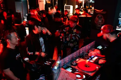 People gathered around a DJ booth at a club