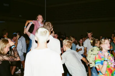 People dancing and celebrating at a crowded event