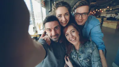 Friends smiling and taking a selfie together