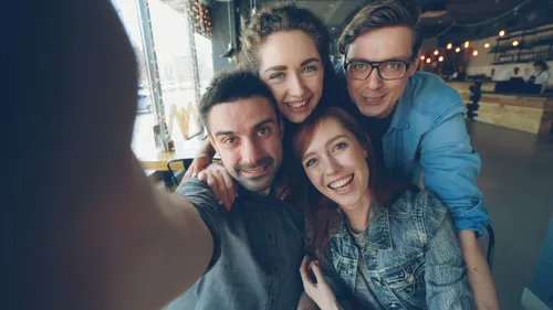Friends smiling and taking a selfie together