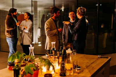 Five people in conversation at a corporate networking event